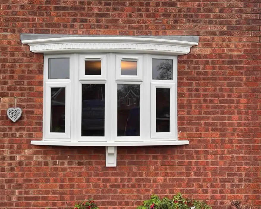 White bay window in a brick façade